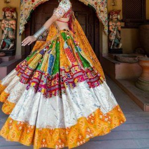 Traditional lehenga choli with heavy mirror work dupatta.